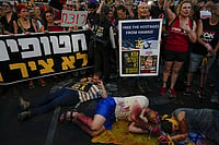 | Photo: AP/Ariel Schalit : Israel-Hamas war: Demonstrators with their hands painted red to symbolize blood attend a protest demanding a cease-fire deal